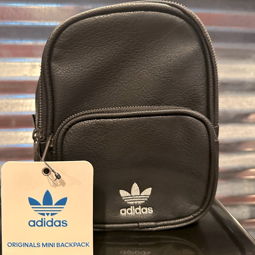 Black leather adidas mini back pack.
